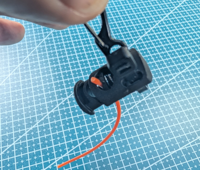 Wire antenna hanging from the cord lock assembly